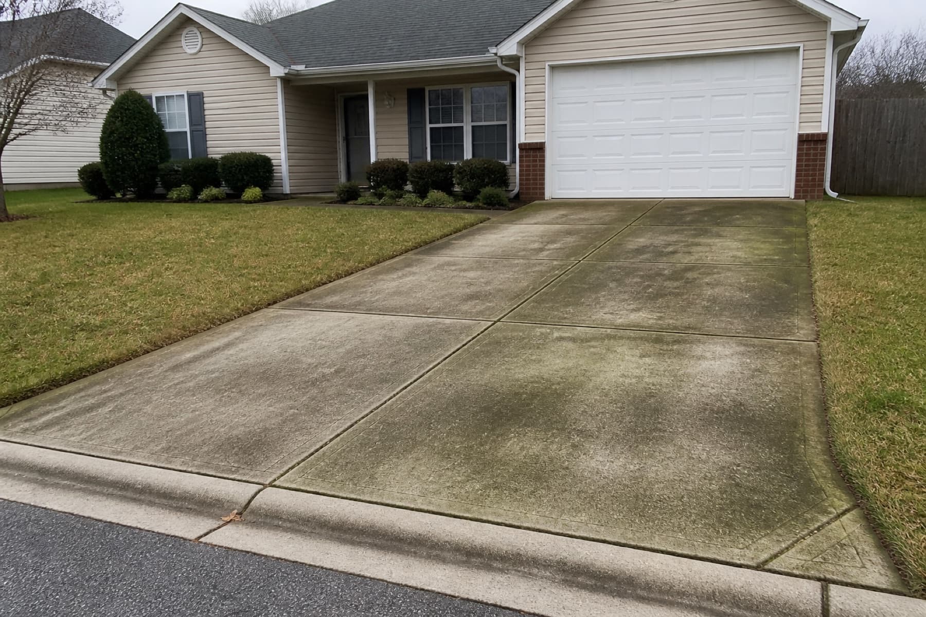 Concrete driveway before a professional pressure washing job